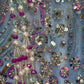 Close-up of a fabric with sequins, beads, and pearls on a blue background